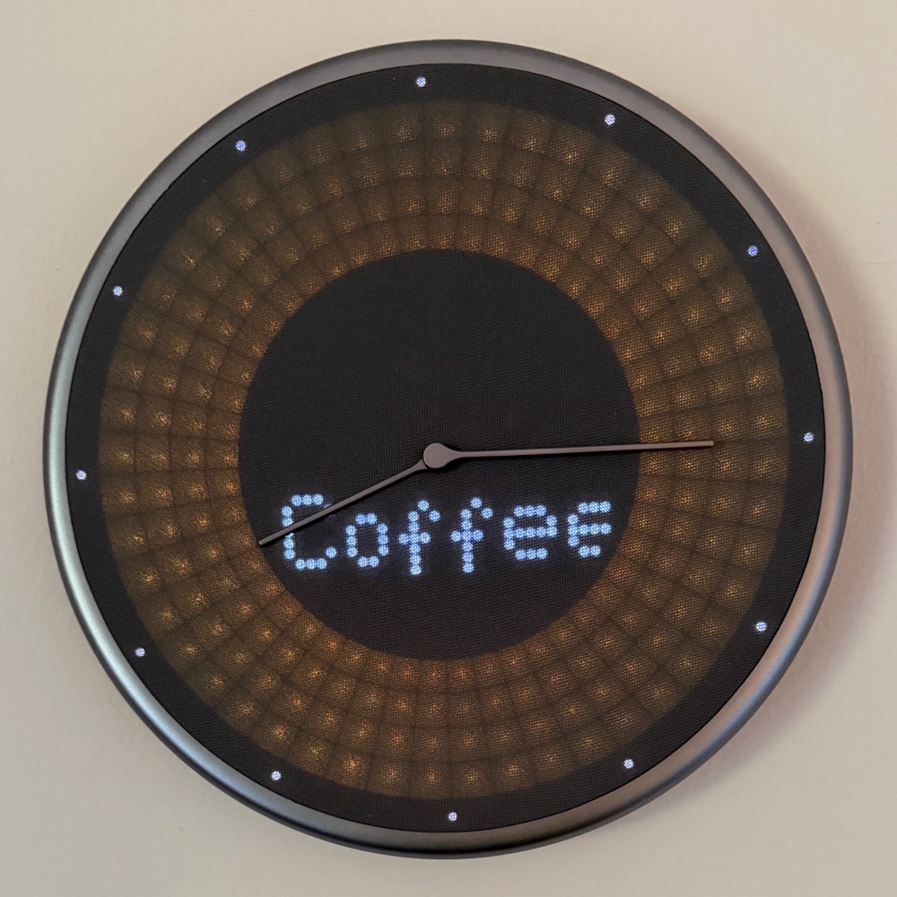 A Glance Clock showing the word Coffee in the centre with a glowing amber ring around it